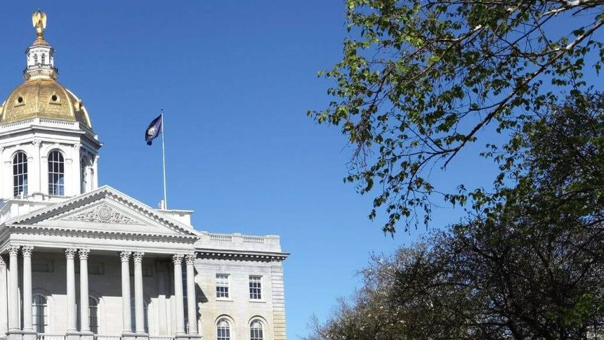 The gold dome of the New Hampshire State House above its granite portico,
           the state flag flying beside it