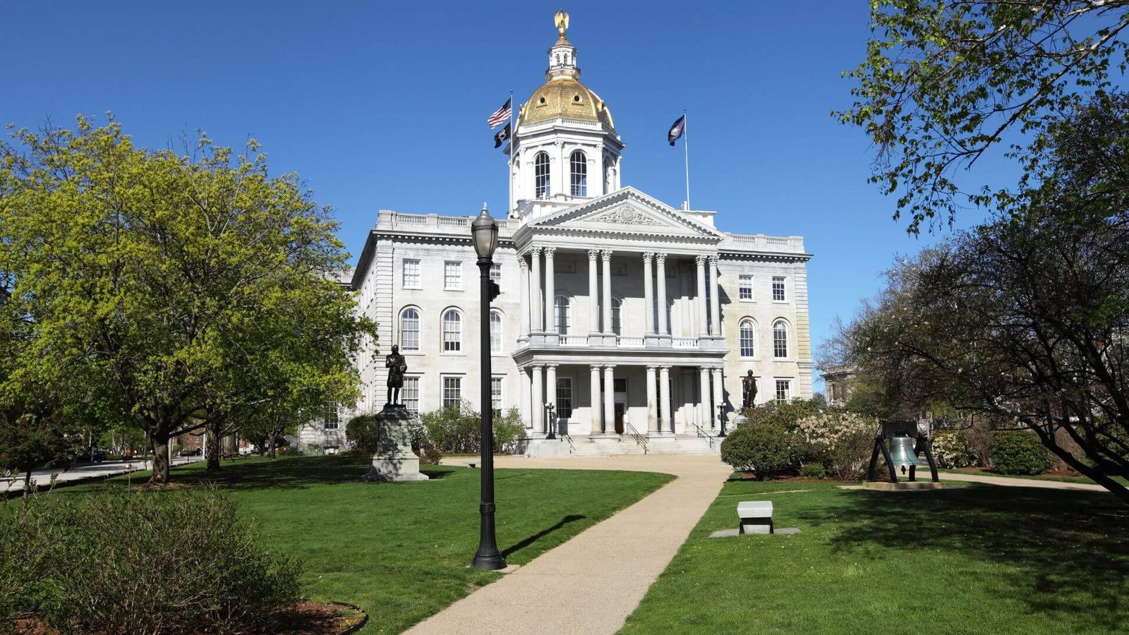 The New Hampshire State House in Concord, its gold dome against a clear sky